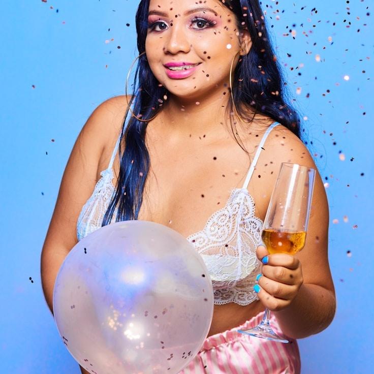 A lavender-haired designer reviewing corporate floral arrangements